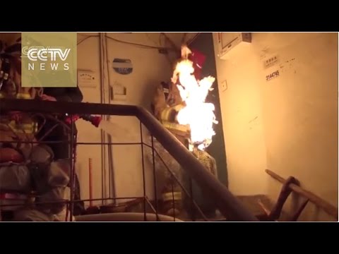 شاهد رجل إنقاذ صيني يهرب بأنبوبة مشتعلة من منزل محترق